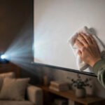 How To Clean A Projector Screen 2026 – Step By Step Guide Wiping a projector screen with a soft cloth