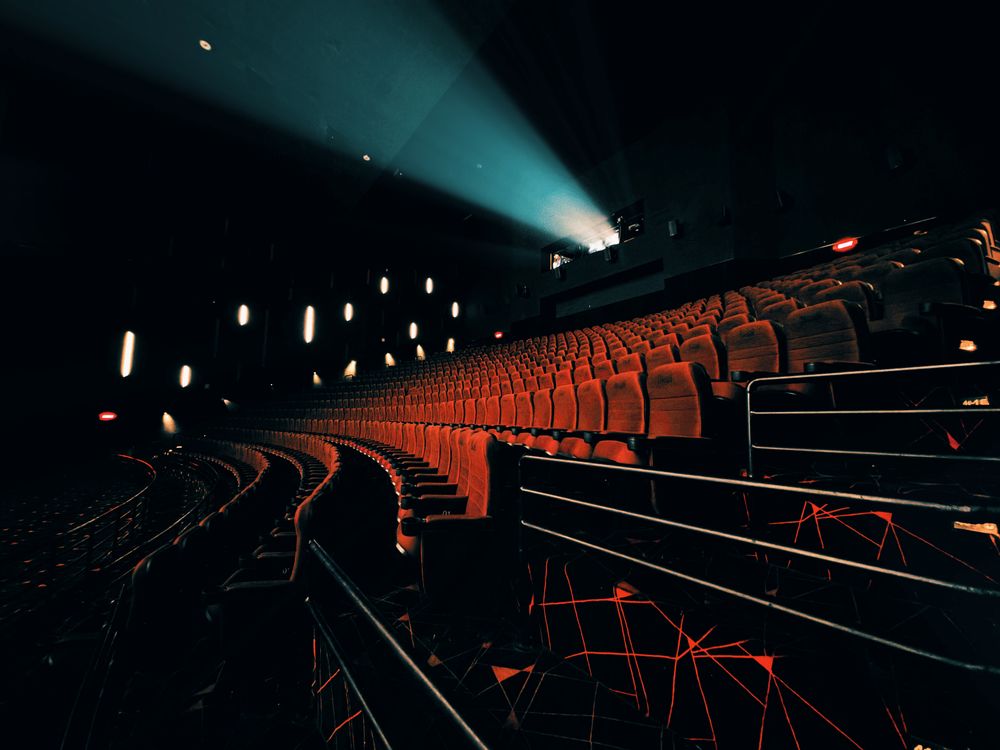 Projector beam lighting up a dark cinema