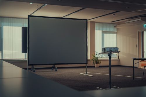 Office with projector and wall-mounted screen - How To Hang Projector Screen From Ceiling